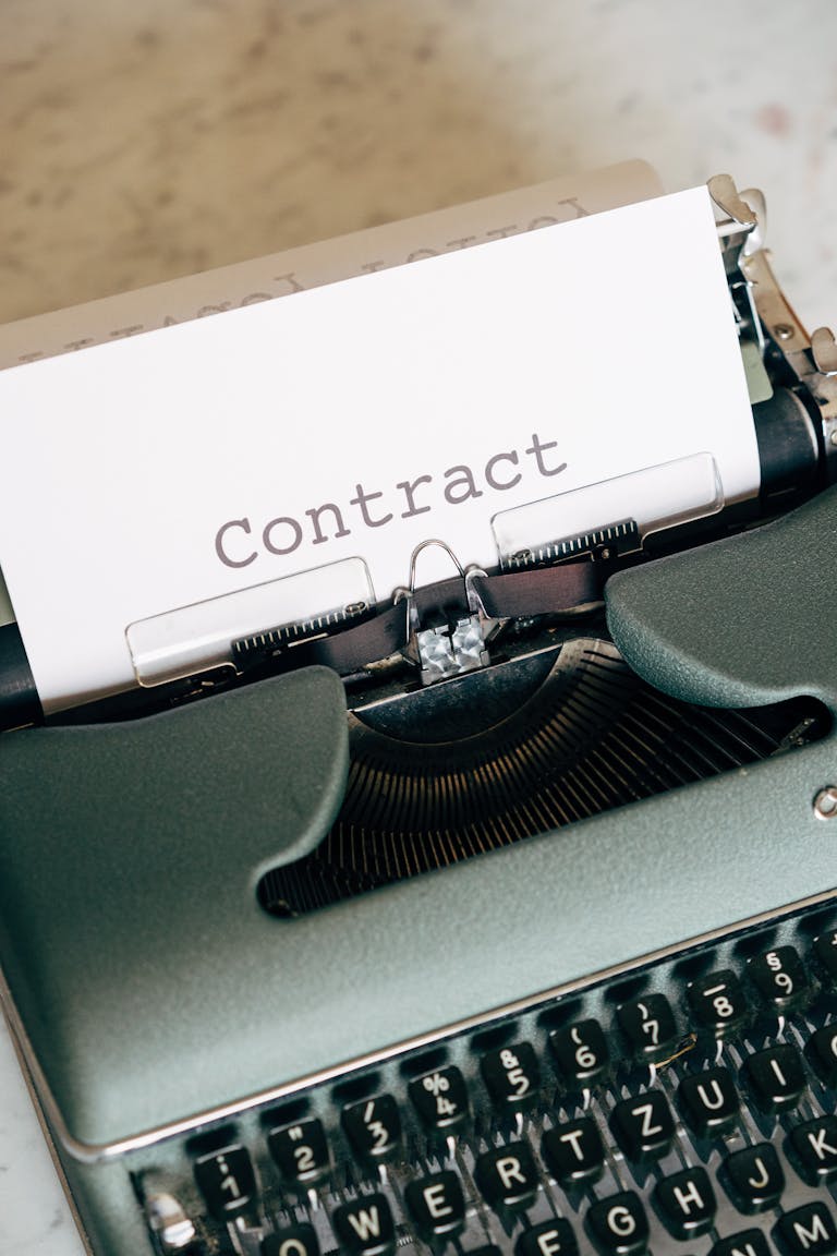 Retro typewriter displaying the word 'Contract', symbolizing traditional document creation.