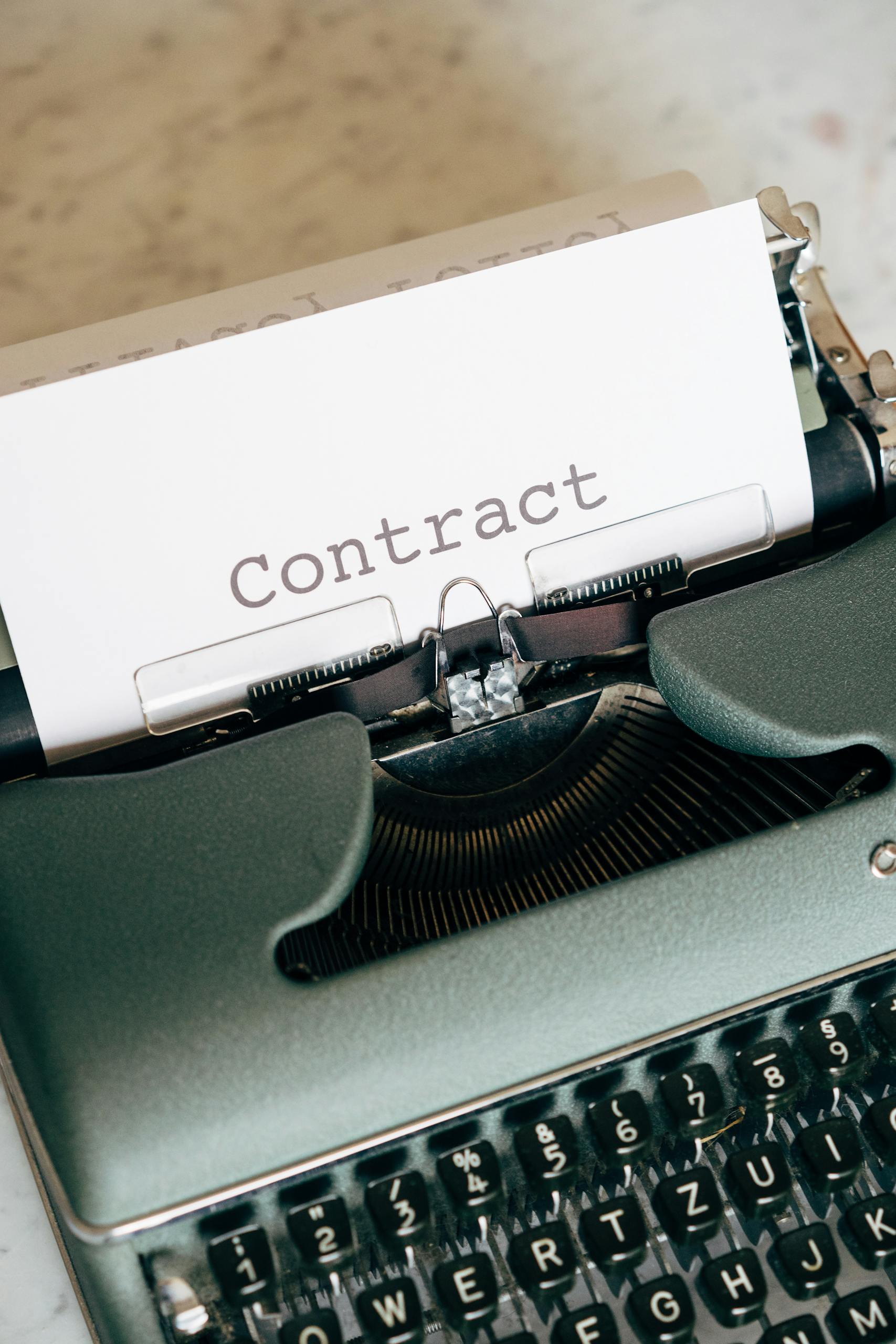 Retro typewriter displaying the word 'Contract', symbolizing traditional document creation.